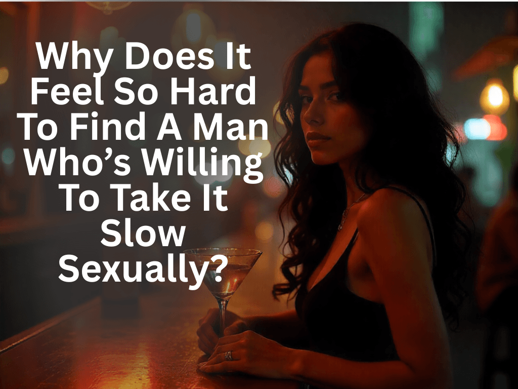 A woman with dark, wavy hair sits at a dimly lit bar, holding a cocktail glass. She wears a black top and looks directly at the viewer with a thoughtful expression. White text overlaid on the image asks, "Why Does It Feel So Hard To Find A Man Who's Willing To Take It Slow Sexually?"